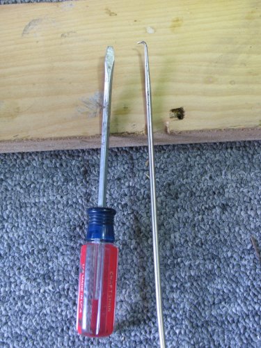 I used the pick to pull back the OEM wire bale that holds the female connector to the injector.  The small screwdriver is then used to keep the bale from snapping back while pulling the bale further out with the pick.
