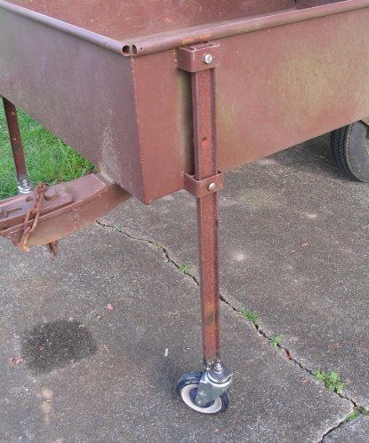 Close-up of the leg.  The upper bolt screws into a nut I welded to the back of the C-channel.  The bottom bolt passes all the way through and is loosely secured with a nut -- not really necessary, just used to keep the leg from wobbling forward and backward.  Next time I think I'll make the legs flare out from the trailer some more to provide better stability as well as make them shorter so more weight is on them and not the rear tire.  If I'm not careful I can put the trailer on one of its rear corners.
