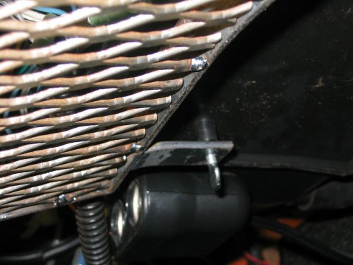 Adjustable tension screw under fresh air box.
