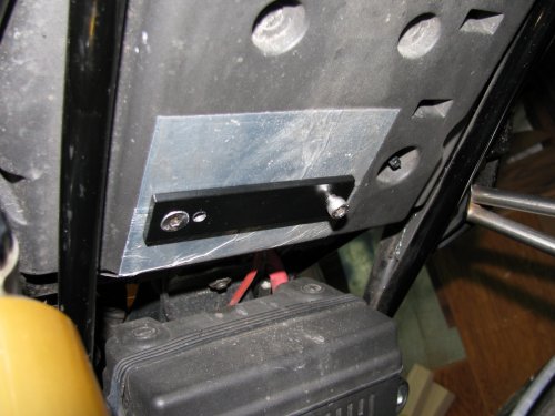 Position the bracket with the right bolt, having the hole centered on it.  Tighten the counter-sunk bolt (left side) into the bracket and seat pan's captured nut.  Remove the bolt from the right side.
