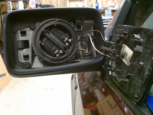 What the interior looks like.  I set the mirror so it was centered in the housing.  I started at the 11 o'clock position and worked my way anti-clockwise (aka counter-clockwise), gently prying the mirror clips away from the ring mount.
