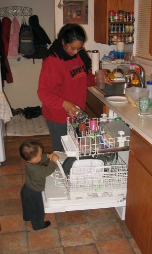 Roni helping mommy load the dishwasher.
