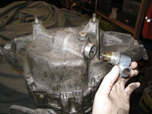 Removing the speedo sender from the damaged tail cover.
