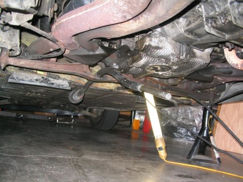 Shift rod removed from both ends.  I later removed it for the install of the new firewall shift bushing as well as pulling the tranny.
