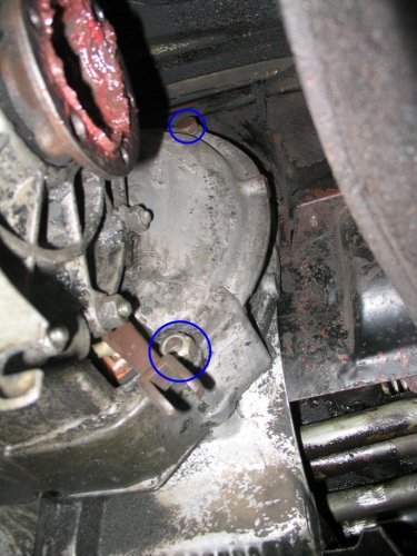 The tranny side of the mounting fasteners.  The lower nut threads on to a stud from the engine side thus you're removing the nut only and no bolt.
