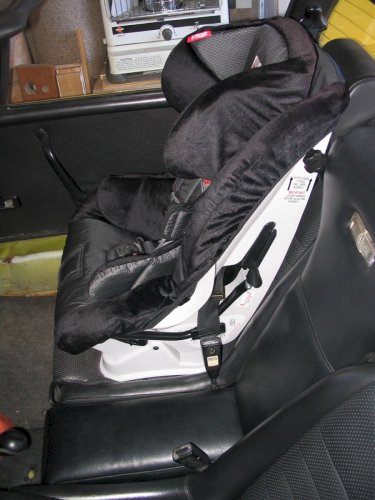 Car seat anchored in with the shoulder belt and a seat belt locking clip.
