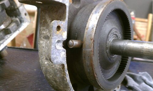 The pin is missing.  Looks melted...???  Without this pin set in the case halves the planetary ring rotates and doesn't allow the forward gear to rotate properly. 
