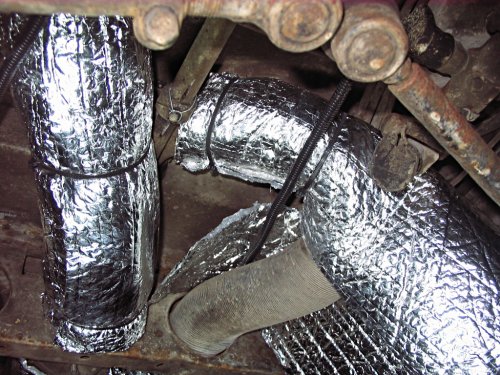 This next sequence shows how I insulated the loop that feeds the main cabin (as opposed to the section that feeds the driver's cabin).  Put an 18" rectangle of the insulation above the duct, cut a slit, and wrap the duct that feeds the cabin.  Thus, I worked backwards, insulating the right arm of the Y-duct last (if laying on your back and looking up).
