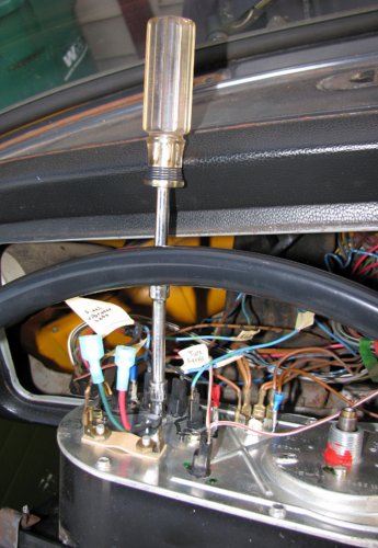 I used a 7/16" socket -- none of my standard metric sockets fit! -- to carefully snug down the VR.  I used the stock sheet metal screw from the original vibrator to secure the VR down.  I also put a stainless steel split washer under the head of the screw to help lock the screw in place.  Just in case...
