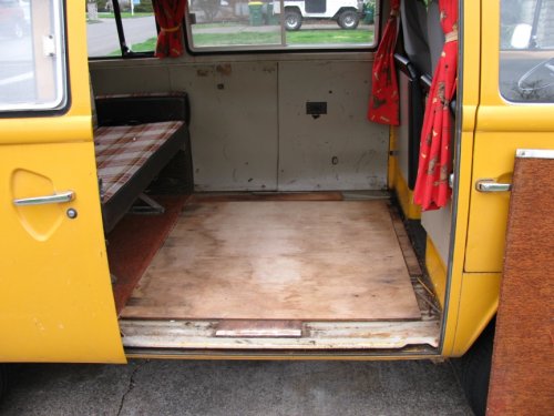 Sheet of plywood with carpet glued to it removed.   Exposed are additional plywood pieces that everything is screwed into.  Note that these pieces of plywood are screwed to the Bus floor.  I really don't think it's necessary but luckily only a couple screws were used.
