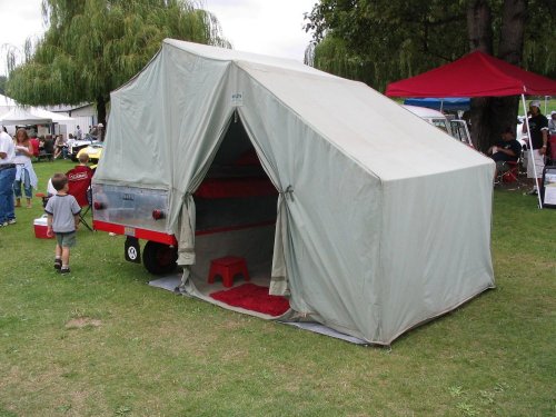 The Bus with it's single-wheel Heilite trailer opened up.  The upper part inside is a bed.
