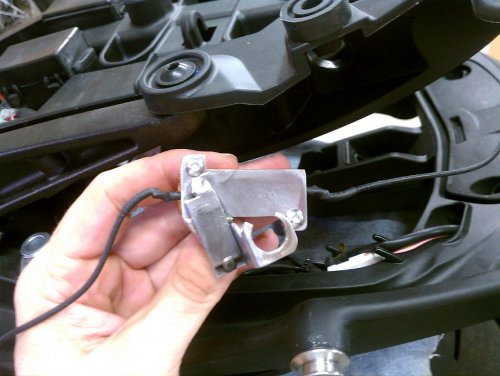 Here's what the left bracket looks like.  Ugly.  But it works, keeping it away from plastics and wires, so that's what matters in the end.
