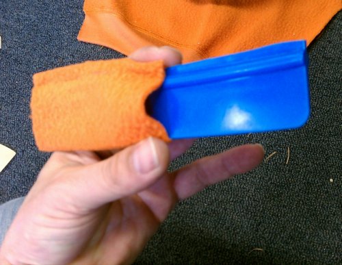 To reduce scratches from the squeegee, wrap it in a semi-thick cloth.  This is mine from a previous film application and is what I used after I noticed small scratches appearing on the film when I first started using the supplied one.
