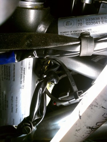 Add a new zip-tie to secure the headlight cables snugly, NOT TIGHTLY.  Now the headlight can be mounted to the two lower anti-vibration mounts and the acorn nuts snugged.  Done!
