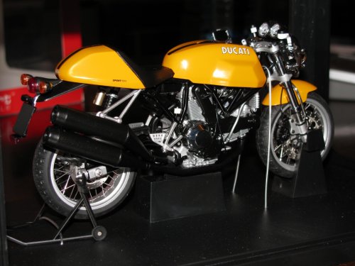 The rear suspension is twist-tied to the exhaust.  Delicate procedure to remove it.  I didn't see its purpose.  The rear stand is 100% functional.
