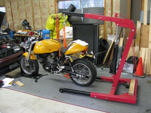 I used my engine hoist to lift my bike by the frame.  I'm so glad I have this!  This was necessary to get the full extension sag measurement as well as lifting the bike to take pressure off the lower bolt so it could be removed.
