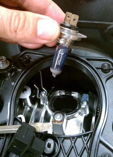 Remove the puny OEM bulb.  Carefully put it aside and don't touch the glass.  You may want to save it as a spare, just in case.
