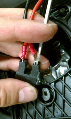 The spade connectors snap in.  If they are difficult to get out (at a later date, say, when replacing the bulb) you may want to use a thin, flat-bladed screwdriver to push the spade away from the female contact as shown.
