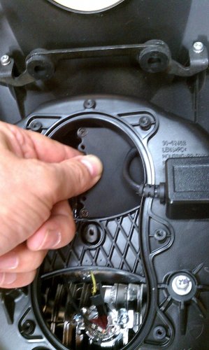 Rotating ballast clockwise to get it in there.  The single electrical connector, or plug, goes down the right side of the headlight housing and then towards the high-beam bulb holder.
