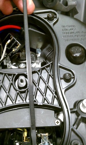 It may not be necessary but I wanted to make sure my ballast wouldn't move around so this is what I did.  I cut a notch at the top and bottom of the hourglass brace that the zip-tie would neatly fit in to.  This will keep the zip-tie from slipping and thus keep a firm hold on the ballast.  A sharp X-acto knife will easily cut through the plastic so operate slowly and carefully.
