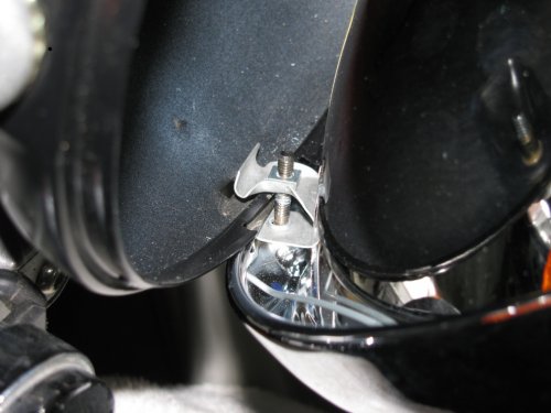 This shows where the retaining clip will rest.  Simply put the top of the headlamp ring on the lip of the headlamp bucket and pivot the bottom section down.  Make sure the retaining clip fits inside the bottom of the headlamp bucket and then gently push the bottom of the headlamp towards the bike body.  Snug retaining screw to secure headlamp but don't over-tighten!
