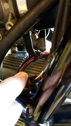 The red line shows the new Motolectric cable is securely zip-tied to keep it from rubbing on the engine.
