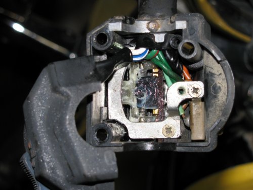 The retaining plate on top of the sliding switch assembly.
