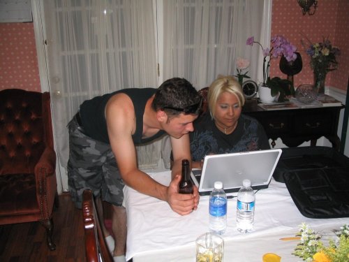 Uncle Justin and Auntie Malini looking at their on-line wedding pictures.
