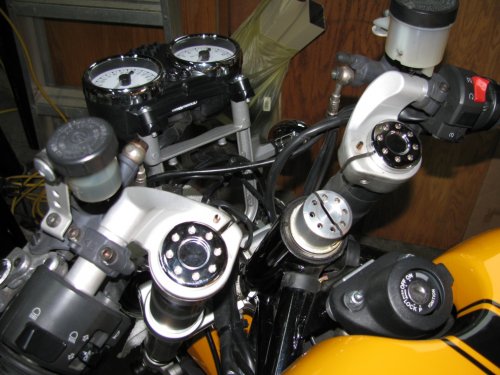 Upper triple tree removed.  Use a 6mm Allen wrench to loosen all clamping bolts.  Alternately tap the bottom of the clip-ons to walk the triple tree and clip-ons up.  I used a block of wood positioned under the clip-on and tapped it with a rubber mallet -- just in case I missed the wood!
