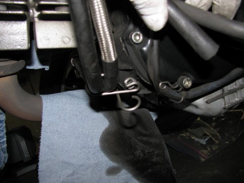 Slide the bracket back down (shown here where it comes from), pop the breather back in the loop, then bolt the bracket back onto the engine.
