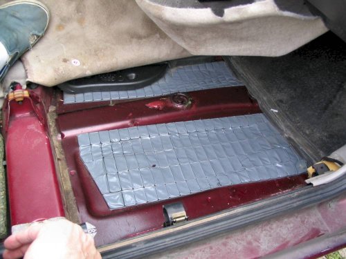 Second layer under right front carpet.  Each cell is filled with sand.  Pad is not bonded to the pan, it's simply laying there.
