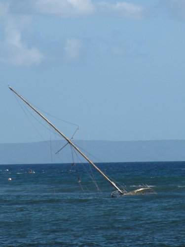Still there!
A wreck left in the shallows, I guess to warn others and help build the reef.  Picture taken from inside Bubba Gumps while waiting for our food.
