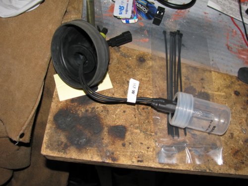 Feed the harness through the rubber cup from the front side.
