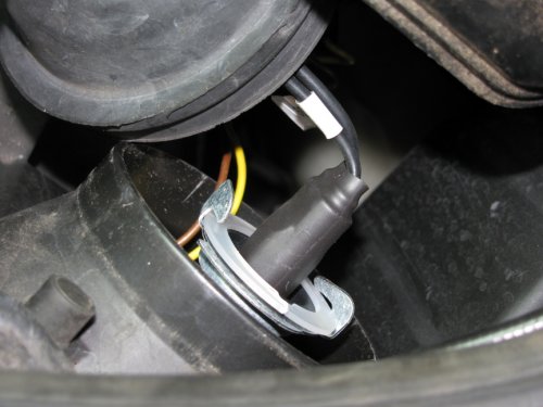 The original bulbs came with a plastic ring to help hold them in their shipping case.  I split it and put it behind the bulb, then carefully pushed the bulb retaining tangs onto the plastic ring.  This kept the tangs more even.  Without them you'll need to push the tangs down a little bit as well as bend them inward in order to retain the bulb.  I oriented the bulb just like the halogen it replaced, tab pointing up.  No shadows were cast, full light is output.
