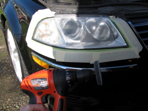 Put tape around the headlamp to protect the paint.  I initially used a battery-powered drill (pictured) but the battery was low on charge so I switched to my 6-amp drill.  Locked the trigger on and started polishing.  Very easy to do and I overlapped per the instructions, moving roughly a half-inch, back-n-forth across the headlamp then some lesser work on the turn signal area (it wasn't as badly pitted).
