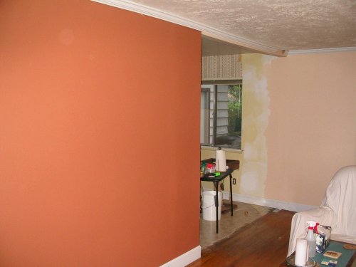 Here you can see the crown moulding going up and also a peek into the dining room.  This is also how we originally planned the opening to end up, however, after viewing some houses being built that had arched opening we decided to step it up and have Bret build us an archway.  Boy are we ever glad we did that!  It was worth the extra cost.
