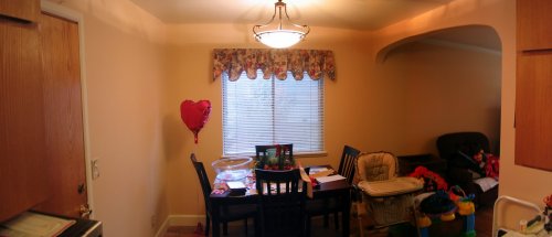 After: Panoramic view (stitched) of the dining room and archway into the living room.
