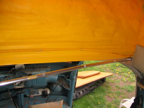 Removing the chrome bow that clamps down the front, lower canvas.
