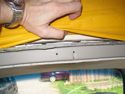 I think that grey blobby stuff is the seal and the white object behind the canvas is the luggage rack.  I know the maroon car in the background is my Jetta :-D
