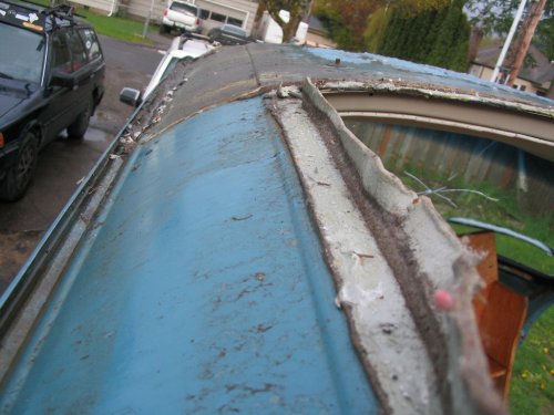 View showing how sealing tape would normally be positioned, with lower metal rails on top of it.
