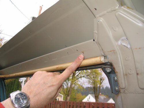 Rivet location for aluminum headliner trim holder on right side (sliding door).
