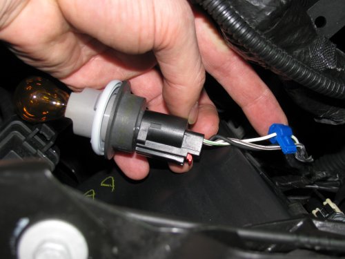 Getting the power ready for the turn signal LED array.
[u]Use a BLUE wire tap-in like what I show.[/u]  The ones that are RED are for smaller wire sizes and the YELLOW ones are for larger wires.  I prefer these because when you insert the [u]insulated male connector[/u] it makes a positive fit and keeps the tap locked on to the wire. -- Left side: Tap into the white wire with the GREEN stripe.  -- Right side:  Tap into the white wire with the BROWN stripe.  -- FYI for both lights:  The black wire [on the outside] is ground, the middle wire is the parking light and the other outside wire is the turn signal.
