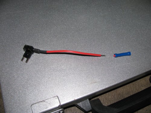 Fuse tap!
This is how to easily and safely tap into some power without compromising the stock wiring or running a long lead through the firewall.  I cut the bullet connector off so I could pass the wire through the grommet hole and so I could use one of my own spade connectors.  To be on the safe side, make sure the fuse tap can handle 25A to 30A minimum.  A 10A fuse tap won't work!  The bottom slot is for the placing the stock fuse while the top is for the accessory and thus the red wire leading from the fuse tap.
