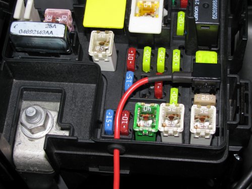 Feed the power feed wire through the grommet and crimp on the connector.  It should be snug in order to keep moisture and dust out.
