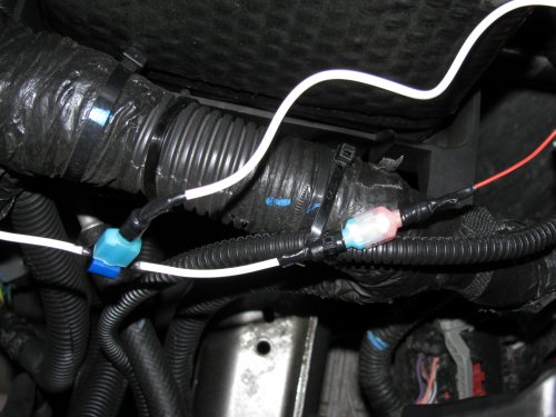 Just a close-up of the power feed from the relay box tapped into the main power feed line that goes between the DRL LED array.  The connector that's connecting white wire to red wire is what's feeding the DRL LED array.
