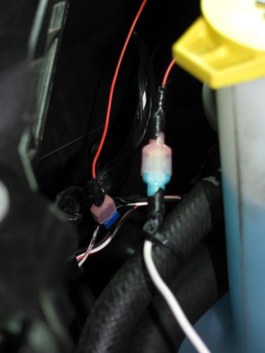 The red wire in the background is the turn signal tap while the white wire in the foreground is the feed to the DRL array.
