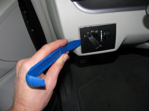 Harbor Freight trim tool (nylon kit, non-scratching, less than $6) used to pry the light switch out.  Very easy.
