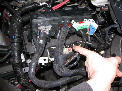 Here's the plug to be modified.  I found it unnecessary to remove ALL of the plugs per the instructions but you can.  Remember to lift the red tab up to unlock the connector.
