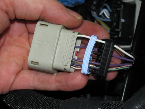 Separate the bottom plug (black) and the seal (light blue) within.  You'll need to unwrap the black electrical tape on the wiring and throw it away.  This will give you the needed slack in the wiring.
