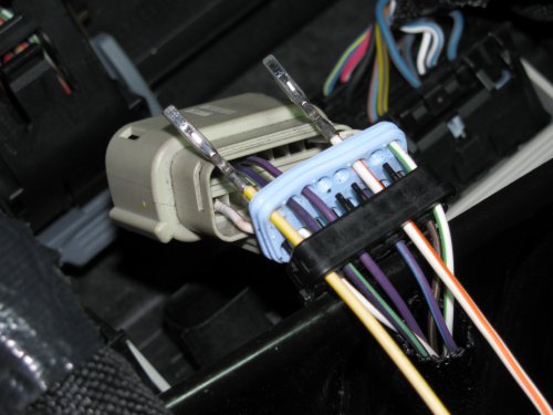 Feed your pigtail wires in, white with yellow stripe on the left in the #16 hole and the white with orange stripe on the right in the #11 hole.  The numbers are on the outside of the black plug.
